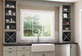 Modern kitchen with sink, cabinets, and window. Brincks offers custom cabinetry for builders.