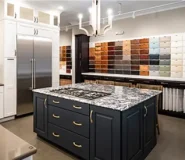 Interior of a kitchen showcasing a sizable island and cabinets.